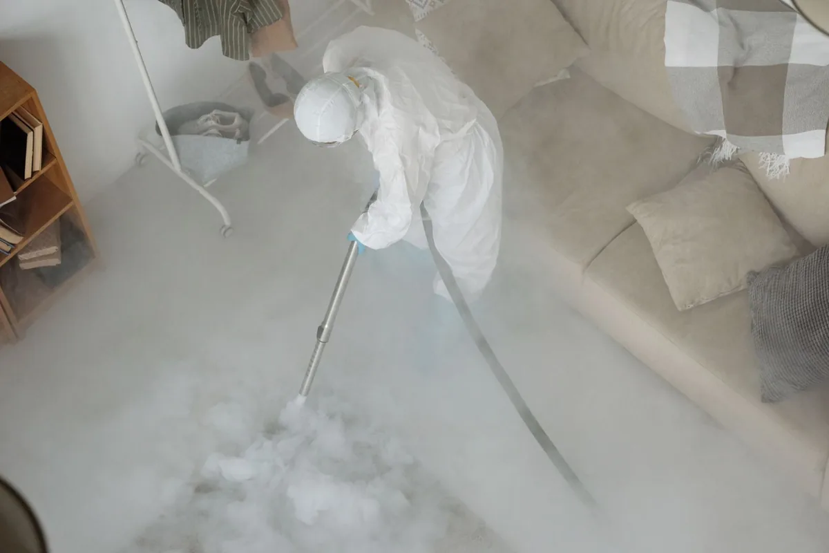 Biohazard cleanup technician in protective equipment, Somerville, TX